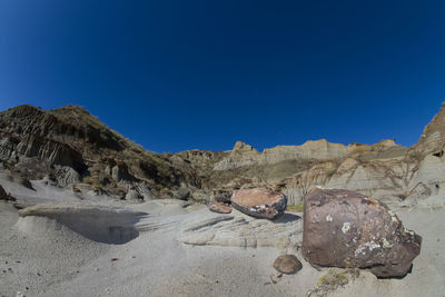 Panoramic view of desert against clear blue sky