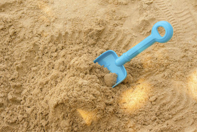 High angle view of toy on sand