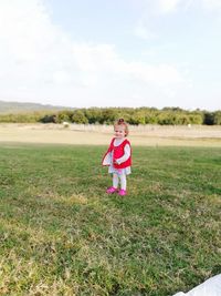 Full length of a girl standing on field