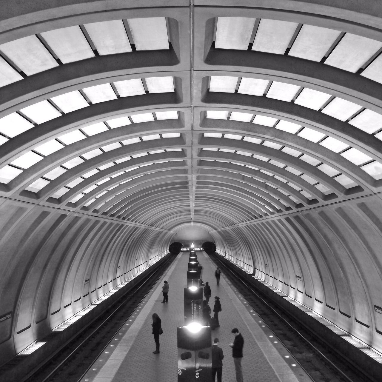 indoors, transportation, ceiling, architecture, built structure, the way forward, diminishing perspective, vanishing point, public transportation, mode of transport, railroad station, rail transportation, modern, illuminated, railroad station platform, travel, high angle view, tunnel, subway station, empty