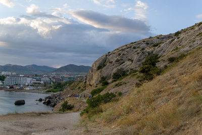 Scenic view of sea and mountains against sky