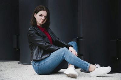 Young woman sitting on floor