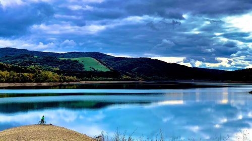 Scenic view of lake and mountains against sky