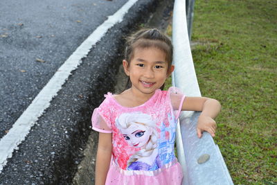 Portrait of smiling girl standing outdoors