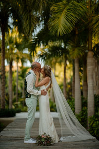 Rear view of couple holding hands