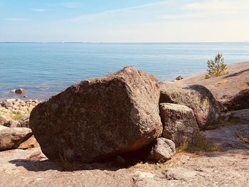 Scenic view of rocks on beach against sky
