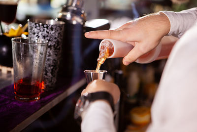 Cropped hand of man working on table