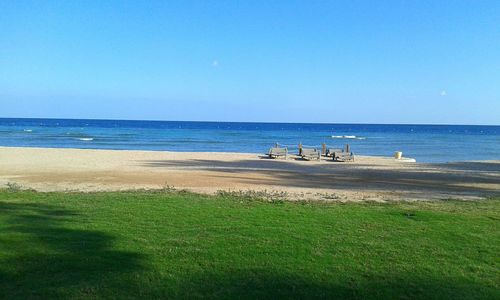 Scenic view of sea against blue sky