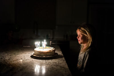 Little girl making a wish before blowing out birthday candles