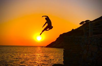 Dives during golden hour on the beach of pomonte on the elba island