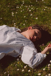 Portrait of young man lying down on land