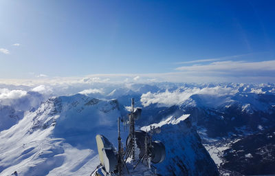 Scenic view of snowcapped mountains against blue sky