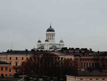 Buildings in city against clear sky