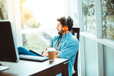 Man using laptop on table at home