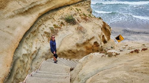 Full length of man on rock at beach