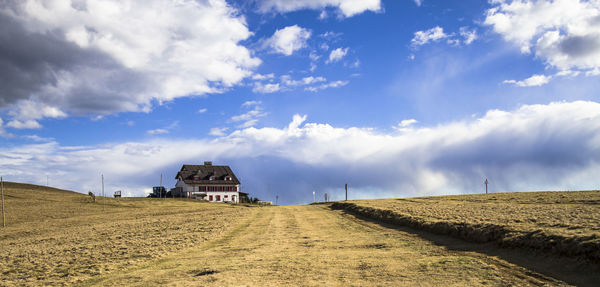 Panoramic view of road amidst buildings against sky