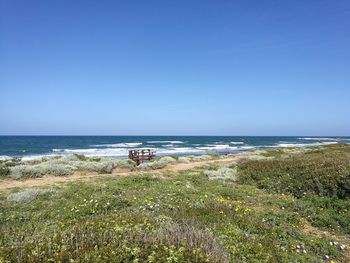 Scenic view of sea against clear blue sky