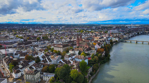 High angle view of townscape and river against sky