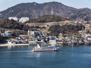 Boats in sea by buildings in city