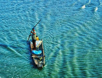 High angle view of man rowing boat in sea