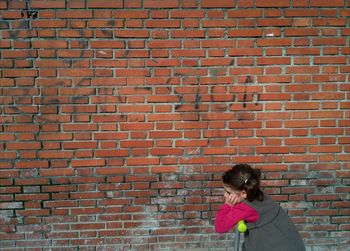 Person sitting on wall