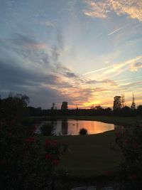 Scenic view of lake against sky during sunset