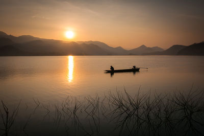 Scenic view of lake against sky during sunset