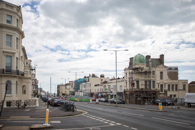 Vehicles on road along buildings