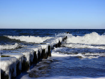 Scenic view of sea against clear blue sky