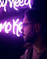 Man portrait with neon lights in night club.