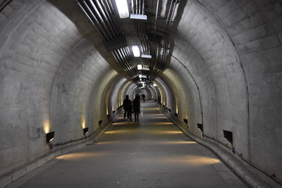 Man walking in illuminated tunnel