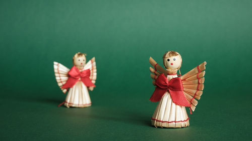 Close-up of toys on table against green background