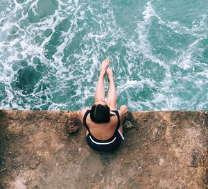 High angle view of man relaxing in sea