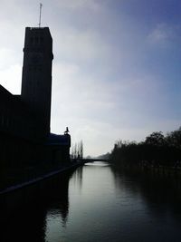 Built structure in river against sky