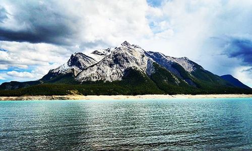 Scenic view of mountains against cloudy sky