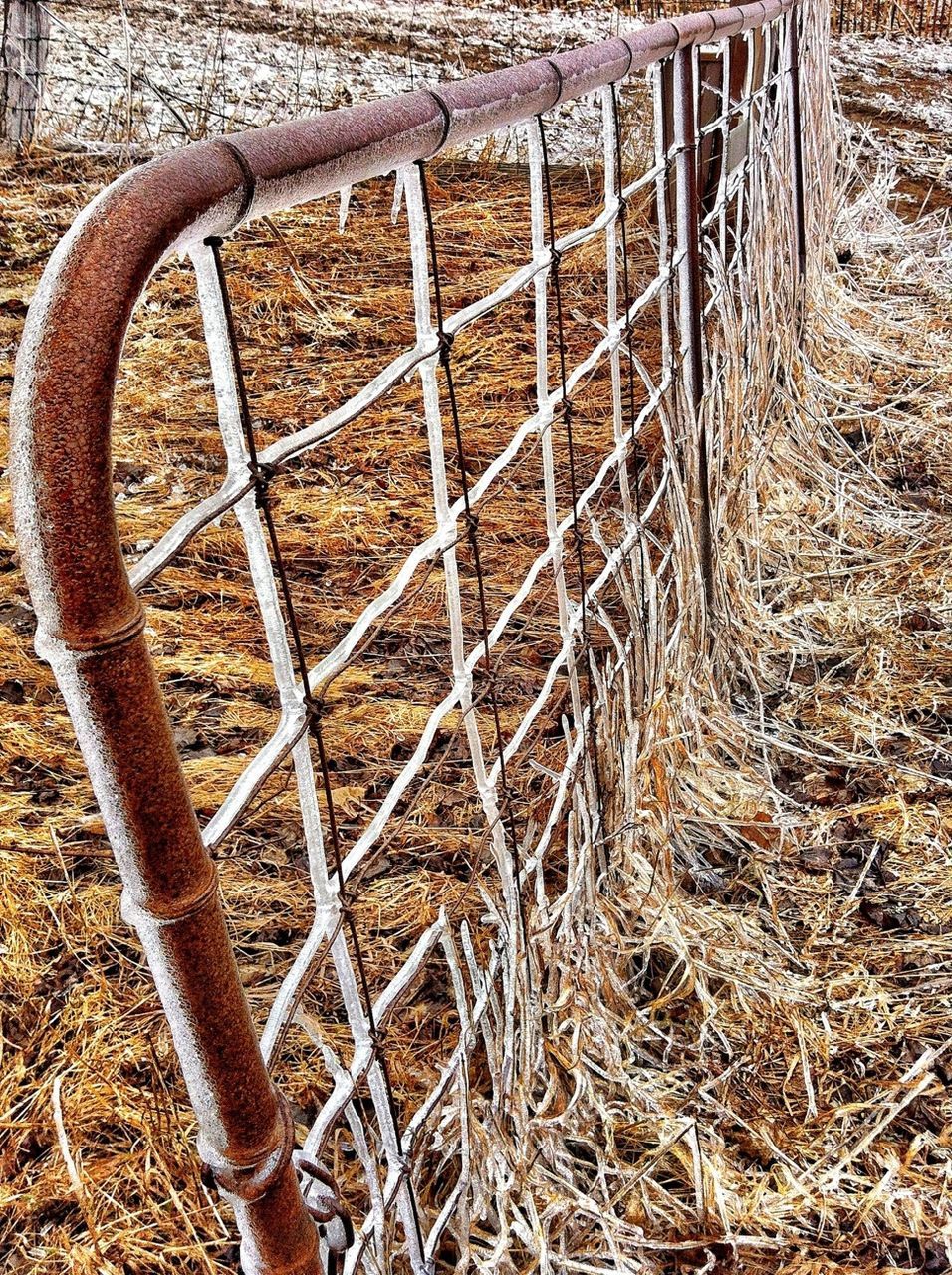 metal, fence, field, rusty, metallic, protection, safety, day, abandoned, wood - material, no people, outdoors, old, grass, railing, rural scene, sunlight, security, high angle view, built structure