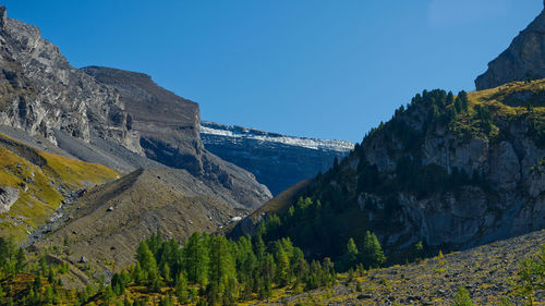 Scenic view of mountains against clear blue sky