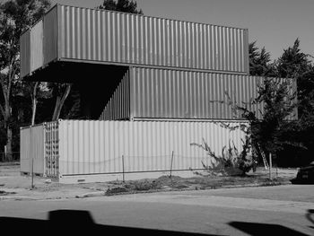 Sidewalk by building against sky