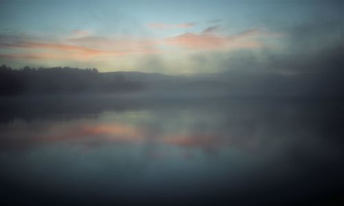 Scenic view of lake against sky during sunset