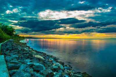 Scenic view of lake against sky during sunset