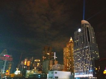 Low angle view of skyscrapers lit up at night