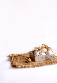 Close-up of bread on table against white background