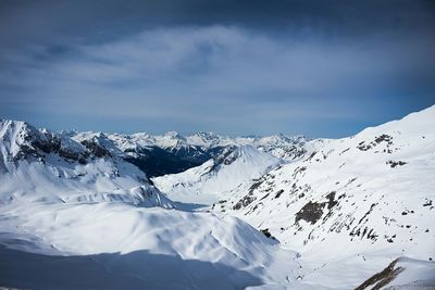 Scenic view of snow covered mountains against sky