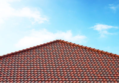 Low angle view of building roof against sky