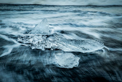 Close-up of wave splashing on frozen sea