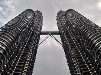 Low angle view of buildings against cloudy sky