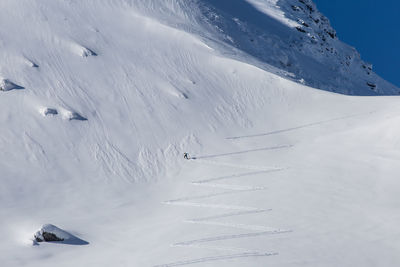 Aerial view of people skiing on snowcapped mountain