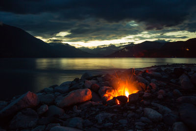 Bonfire at lakeshore during dusk