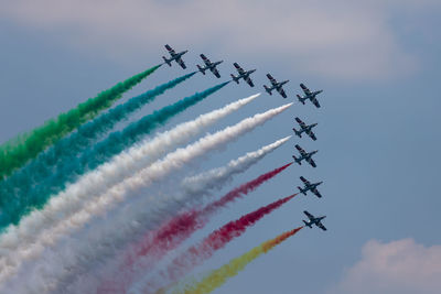 Low angle view of airshow against sky