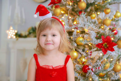 Portrait of cute girl with christmas tree